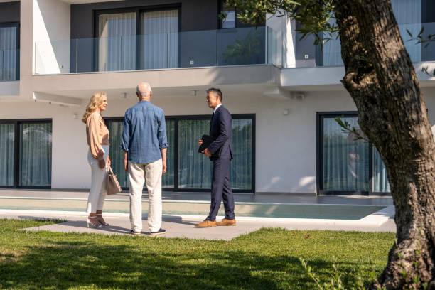 istock Real estate agent showing house 1829978405