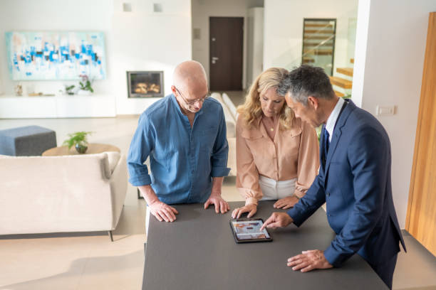 istock Couple and real estate agent looking at tablet 1829978431
