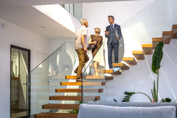 istock Real estate agent and clients walking upstairs 1829978709