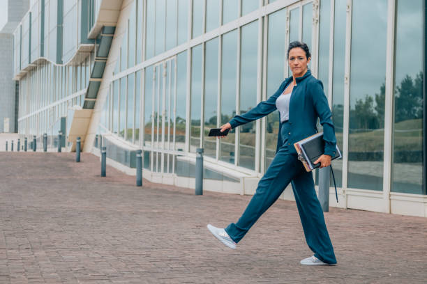 istock business woman walking full length 1829987570