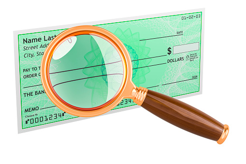 Bank check with magnifying glass. 3D rendering isolated on white background