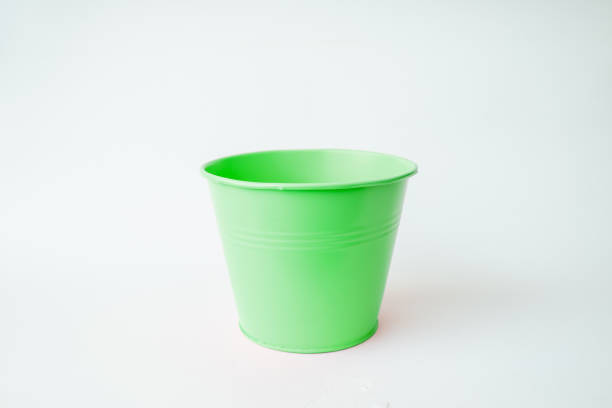 istock A toy green bucket against a white background.Copy space. 1830016124