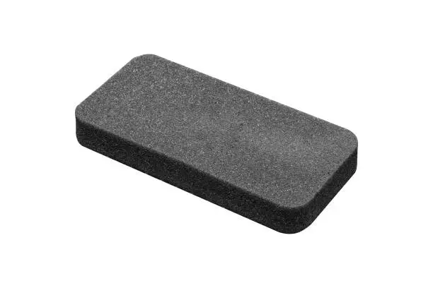 Photo of Dark gray foam rubber lodging with rounded edges is isolated on white background.
