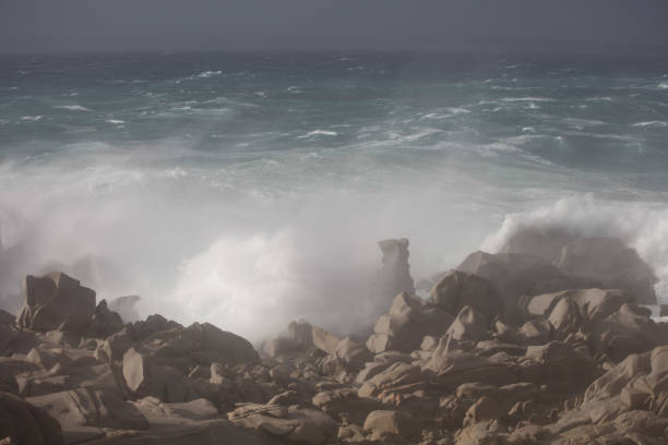 Gusty winds and huge waves hitting the massive granite boulders of the cape, dubbed Capo Testa, close to Santa Teresa Gallura, in Sardinia. The perilous sea comprised in the narrow strait Bocche di Bonifacio, between Corsica and Sardinia, is showing off all its intimidating power