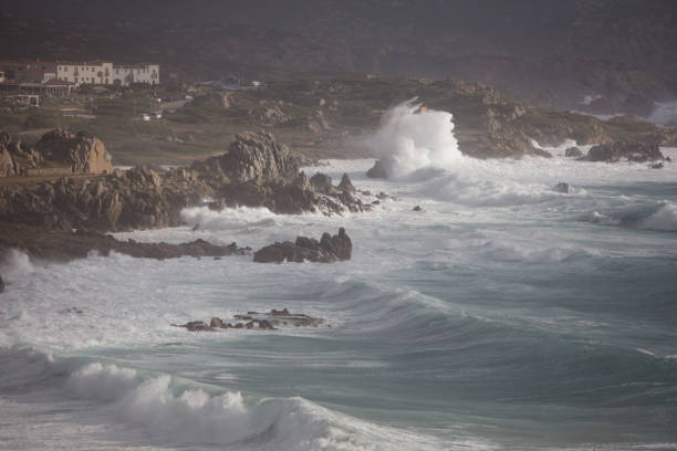 Gusty winds and huge waves hitting the massive granite boulders of the cape, dubbed Capo Testa, close to Santa Teresa Gallura, in Sardinia. The perilous sea comprised in the narrow strait Bocche di Bonifacio, between Corsica and Sardinia, is showing off all its intimidating power