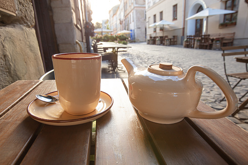 cup of tea and teapot on the table in outdoor cafe in Lviv, Ukraine
