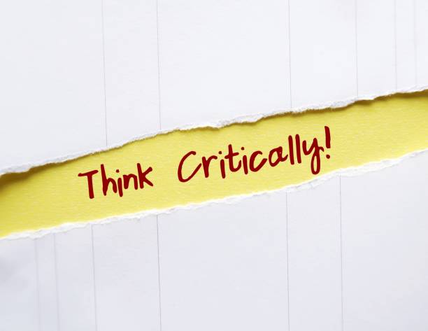 istock Torn yellow paper with handwritten text THINK CRITICALLY! to remind self to focus on logical and rational process of evaluating about what to do or what to believe 1830041130