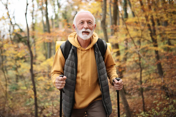 istock Senior Hiker Navigates the Forest with Poles 1830062977
