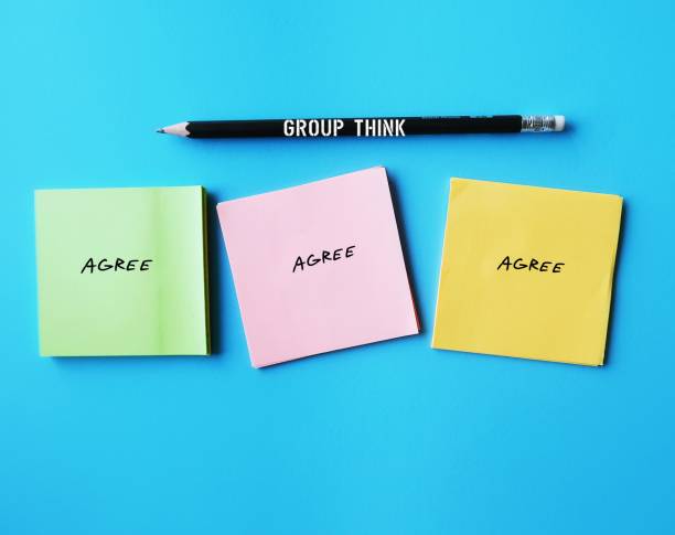 istock Notes on blue background with words AGREE concept of Groupthink -  phenomenon occurs when group reaches consensus without critical reasoning or evaluation but based on common desire not to upset group 1830065971