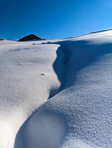Winter landscape: snow-covered stream.  Terrain, snow crevice. Light-shadow contrasts in the snow