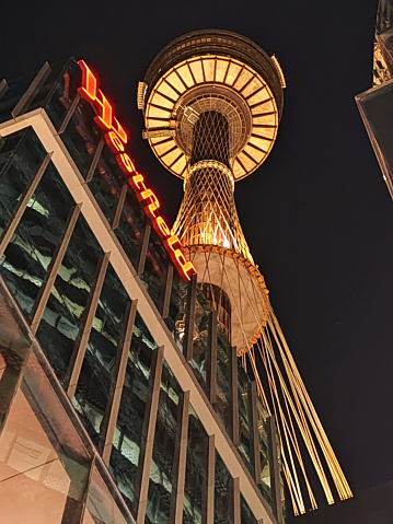 Low angle view at night of the tall Sydney Tower, also known as Centrepoint Tower. It stands 309 m above the Sydney central business district (CBD), located on Market Street.