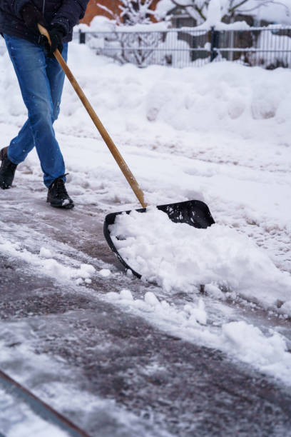 istock A man shovels snow from a sidewalk 1830090214
