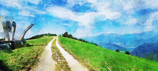 A watercolor effect on a photo of gravel road on the top of the hills over Most na Soči, near the Široko farm and guesthouse. A photo spot for tourists with a hardwood sculture over a bench on the right, a anoramic view of the Soča valley and the Julian Alps in the background. A watercolor effect on a real photo.