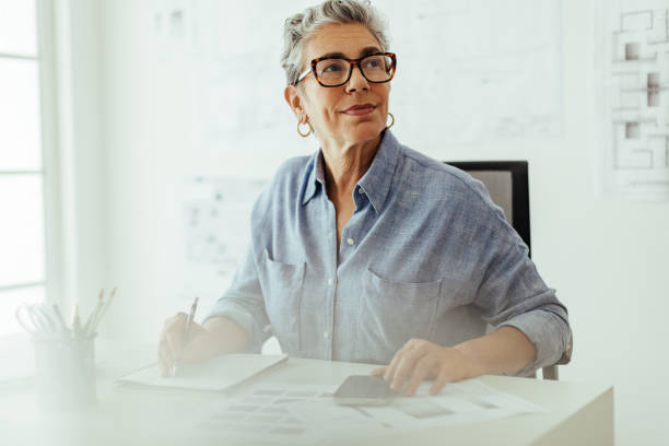 istock Project planning: Pensive interior designer making a to do list in her offfice 1830110683