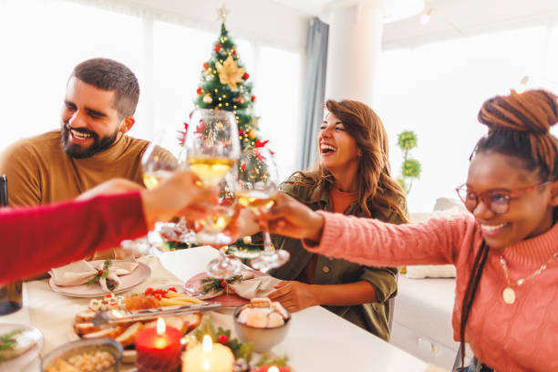 istock Friends making a toast while having Christmas dinner at home 1830113977