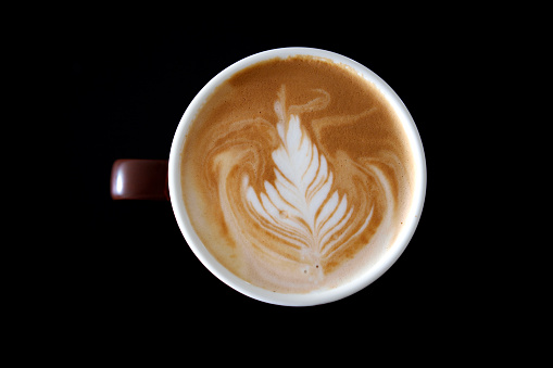 Coffee cup with coffee latte on black background.