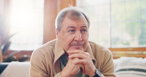 istock Thinking, reflection and senior man on sofa in living room with memory or dreaming face on walking stick. Relax, idea and elderly male person in retirement with alzheimers disease in lounge at home. 1830134122