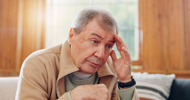 istock Thinking, stress and senior man on sofa in the living room with memory or reflection face expression. Relax, idea and elderly male person in retirement with dementia disease in lounge of modern home. 1830134128