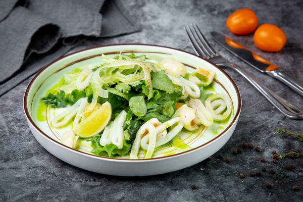 istock salad with arugula, parsley, lime and squid rings, side view 1830142384