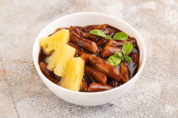 istock Tteokbokki or Topokki, fried rice cake stick, on gray concrete, side view 1830156612