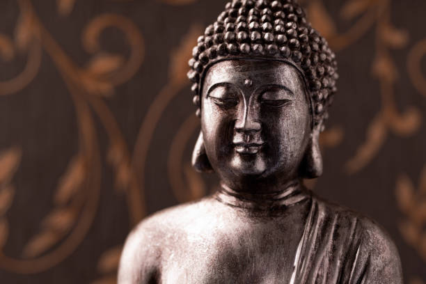 istock Meditating Buddha Statue on dark background. Close up. Copy space. 1830158240