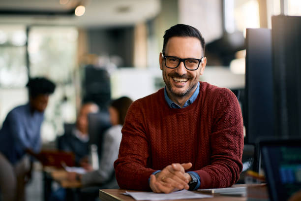 istock Happy entrepreneur working at IT office and looking at camera. 1830162023
