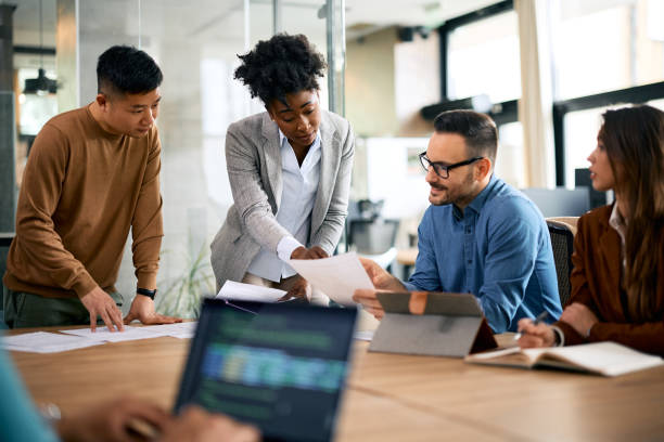 istock Multiracial business team analyzing reports on a meeting in the office. 1830165787