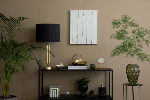 istock Interior design of elegant living room interior with mock up poster frame, modular sofa, patterned carpet, black rack, lamp, stylish sculpture and personal accessories. Home decor. Template. 1830174432
