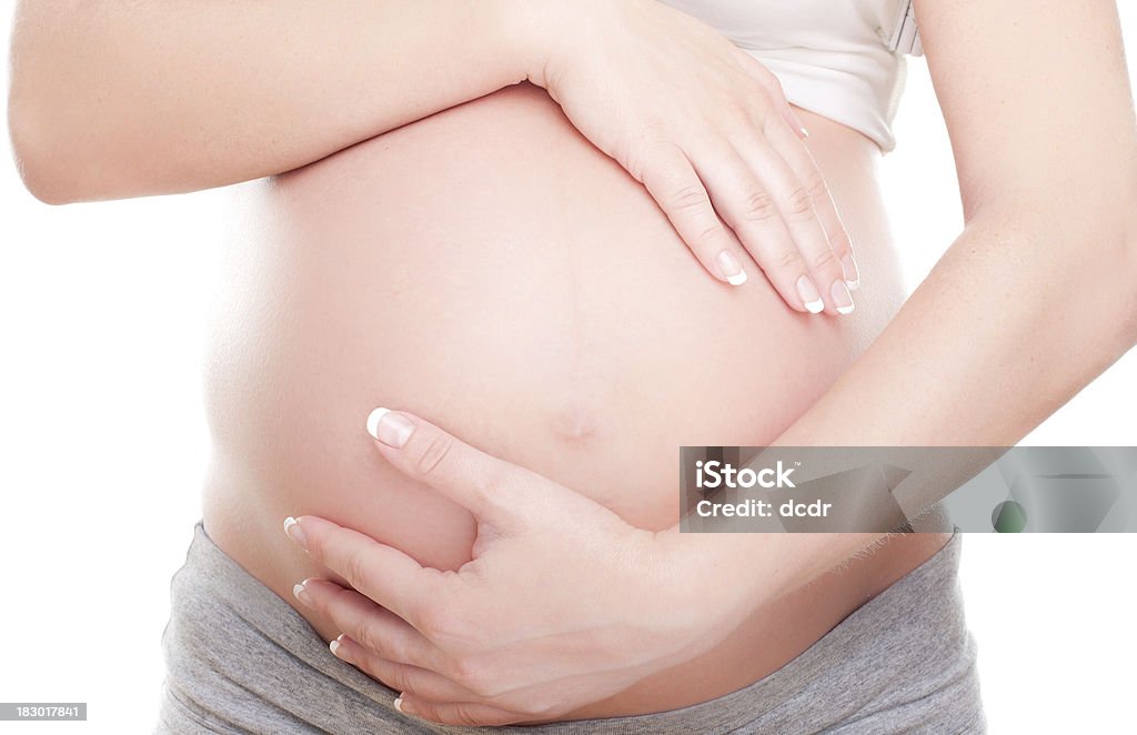 Mujer embarazada sosteniendo su vientre - Foto de stock de Doctora libre de derechos