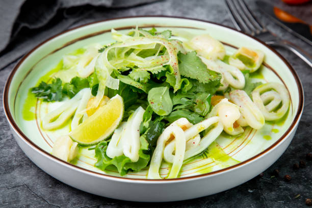 istock salad with arugula, parsley, lime and squid rings, side view 1830182666