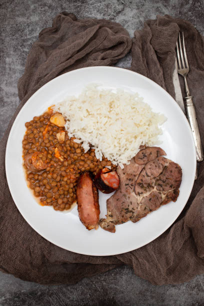 istock grilled meat, sausage, lentils and boiled rice 1830184325