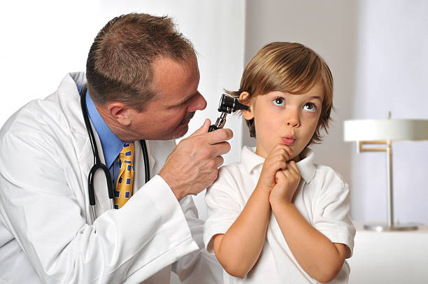 istock Nervous Young Boy with his Doctor Getting an Exam 183018672