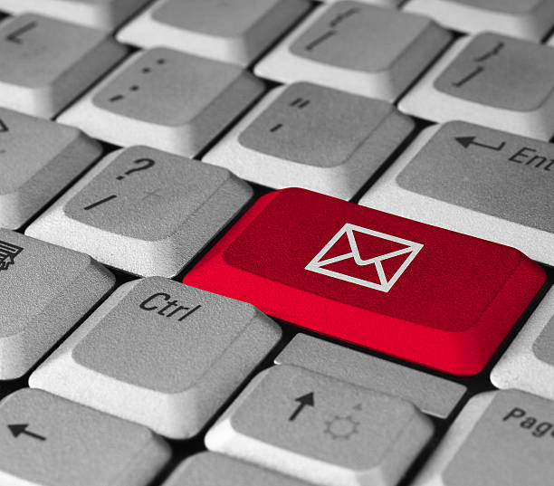 Modified computer keyboard with a red email button stock photo