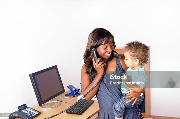 African American Woman Holding Her Son While Phone Stock Photo - Download Image Now - Baby - Human Age, Telephone, Women