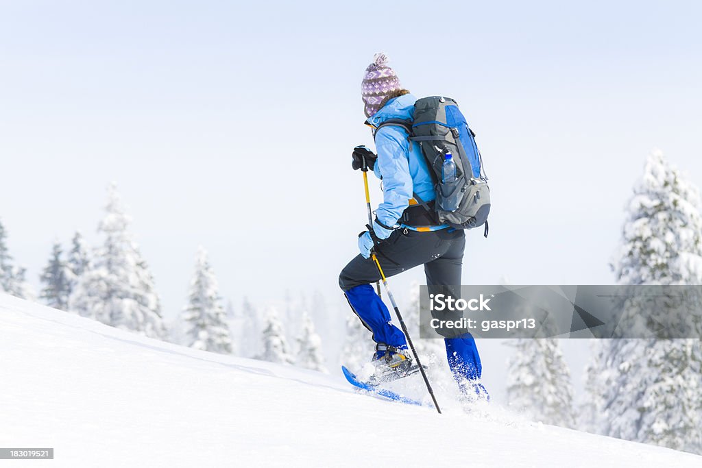 snowshoeing woman snowshoeing towards the top of the hillCHECK OTHER SIMILAR IMAGES IN MY PORTFOLIO.... Snowshoe Stock Photo