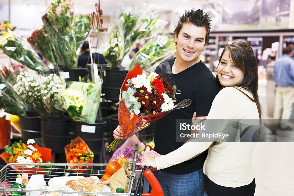 Affettuoso coppia aggiungere fiori al proprio carrello acquisti - Foto stock royalty-free di Abbigliamento casual
