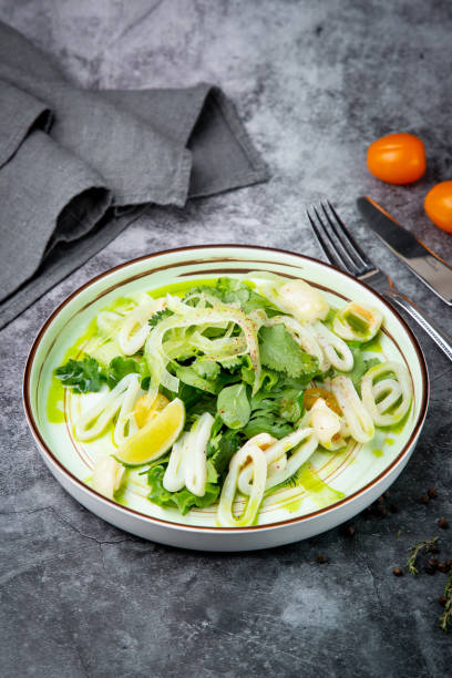 istock salad with arugula, parsley, lime and squid rings, side view 1830205981