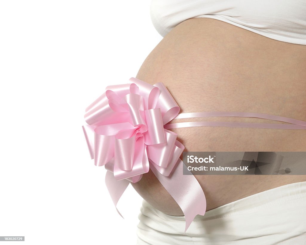 Expecting a girl "Pregnant lady with a pink bow, expecting a girl, isolated on white." Abdomen Stock Photo