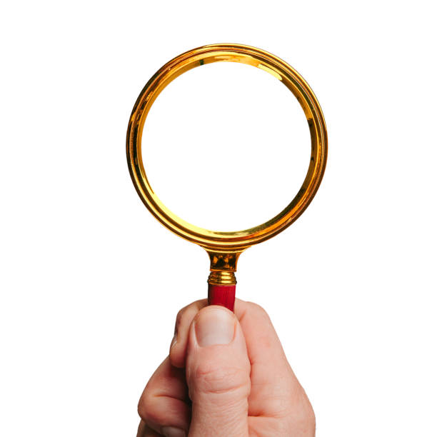 a hand holding a lens on a white background - magnifying glass lens holding europe imagens e fotografias de stock