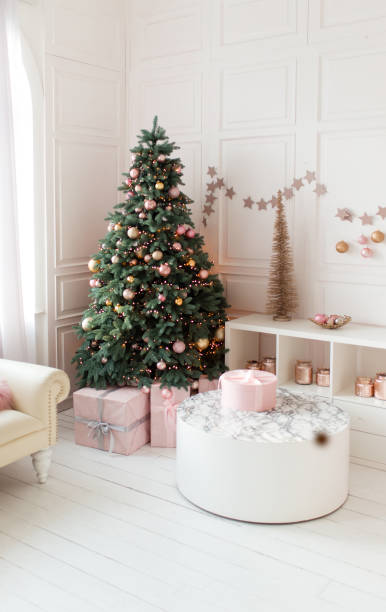 istock Christmas home interior. White room with a large decorated Christmas tree, gift boxes. Holiday decor. 1830210660