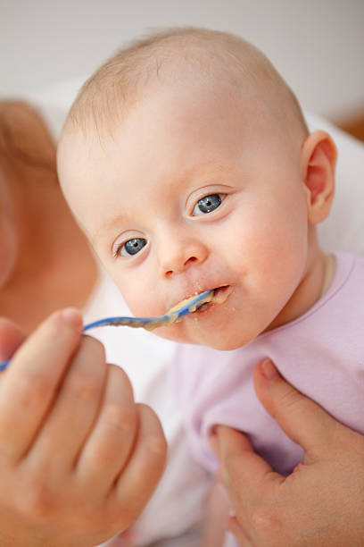 istock Mother feeding her baby 183021421
