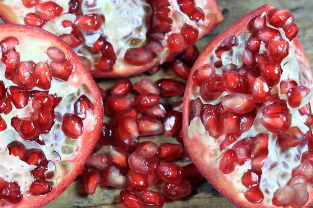 istock Red Pomegranate seeds on the wooden background 1830216113