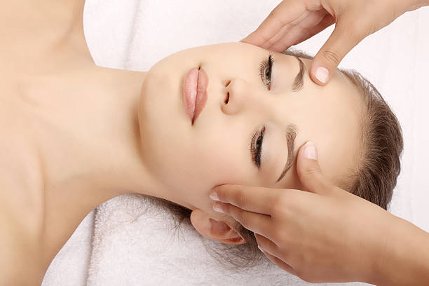 istock young woman receiving head massage 183021732
