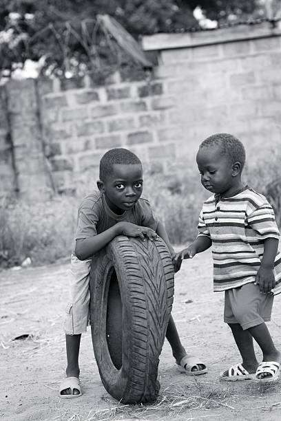african schoolboy eating traditional food (fish and fufu).