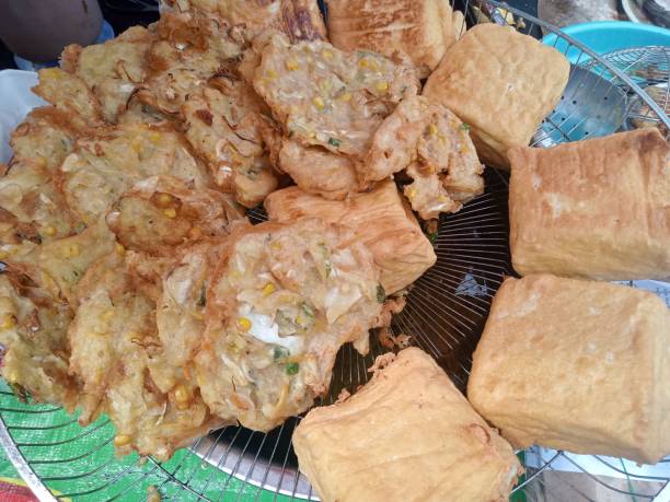 istock fried tofu and fried bakwan lifted from the frying pan 1830219996