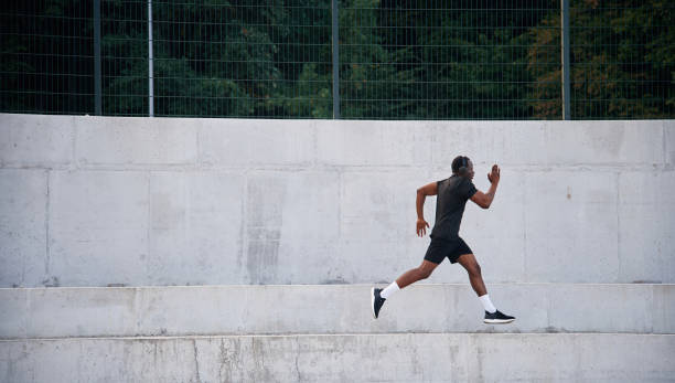istock Side view. Sportive black man is running, morning routine 1830220541