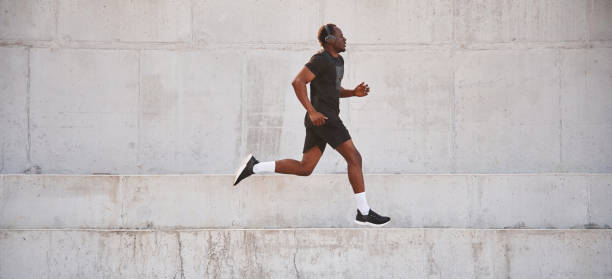 istock Side view. Sportive black man is running, morning routine 1830220549