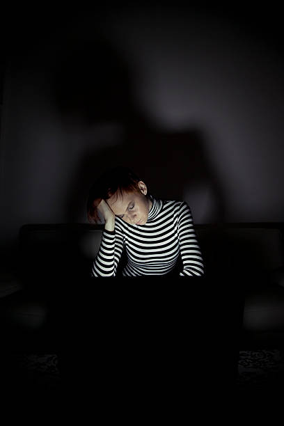 istock Tired young woman working late at night 183022244