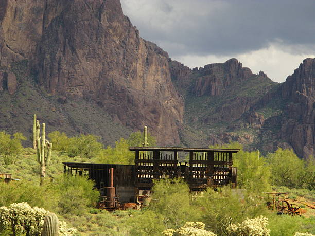 Abandoned mining equipment in the desert of Arizona with the Superstition Mountains in the background.