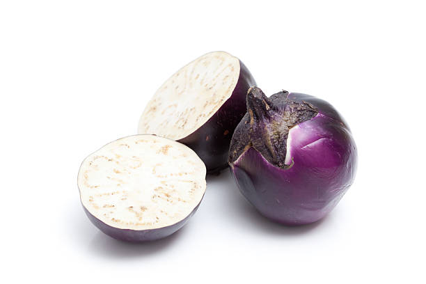 Cut Sicilian Eggplant "Half of a Sicilian Eggplant, and a whole one. A popular variety at South Jersey farm stands. Isolated on white." terryfic3d stock pictures, royalty-free photos & images